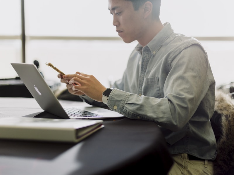 Student reviewing an online lecture while taking notes